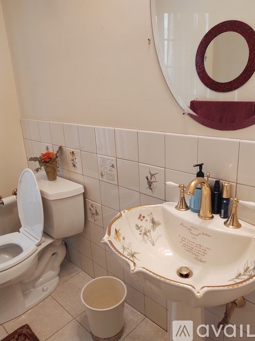A white toilet sits next to a sink in a bathroom.