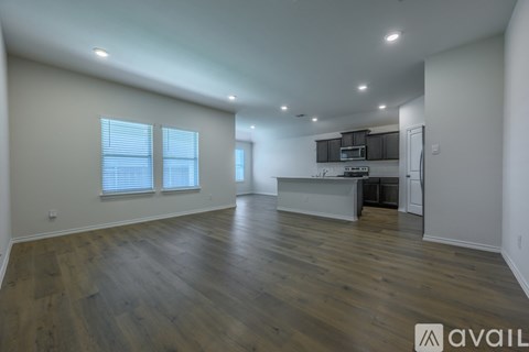 A kitchen with a white countertop and black cabinets.