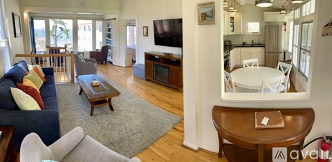 A living room with a blue couch and a wooden coffee table.