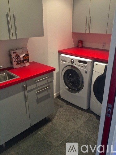 A small laundry room with a washer and dryer.