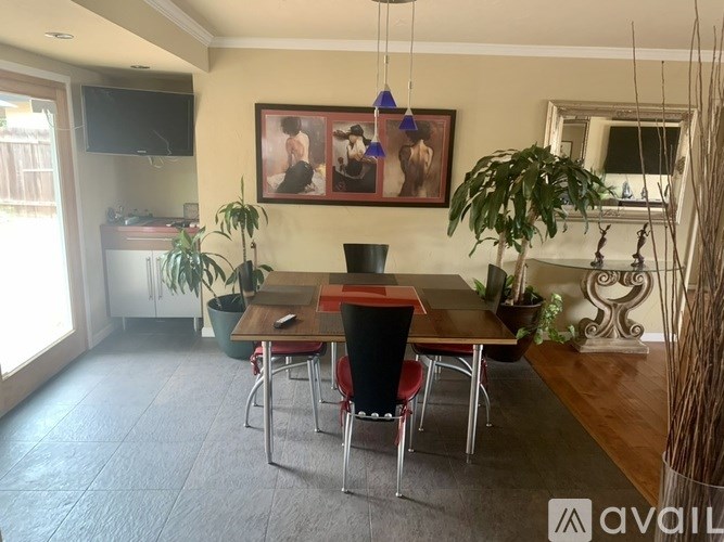 A dining room with a wooden table and chairs.