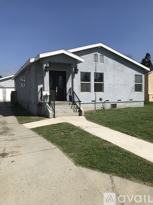 A white house with a black door and windows.