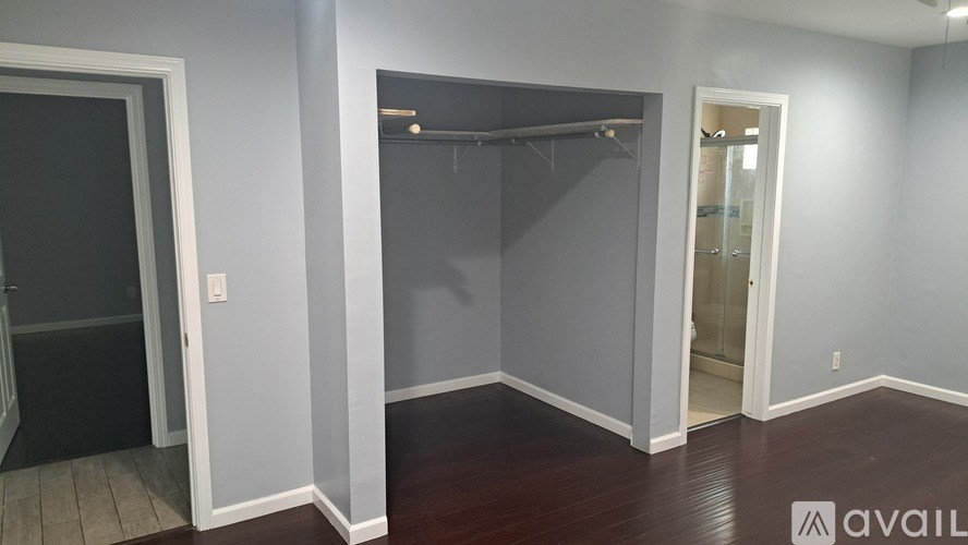 A room with a dark door and a light-colored wall.