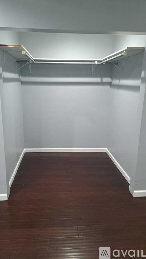 A room with a wooden floor and white walls.