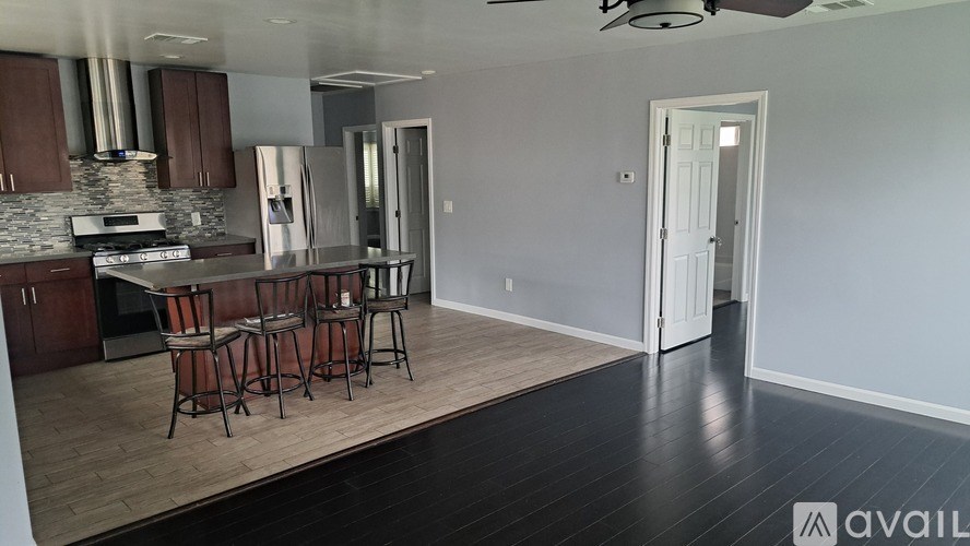 A kitchen with a dining table and chairs is available for rent.