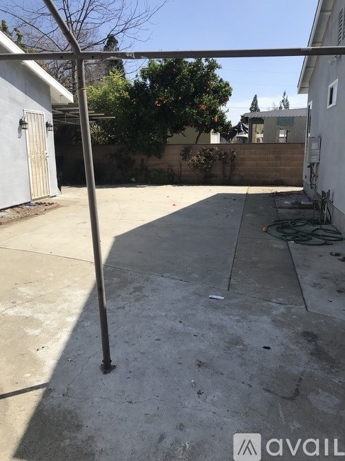 A concrete patio with a metal pole in the middle.