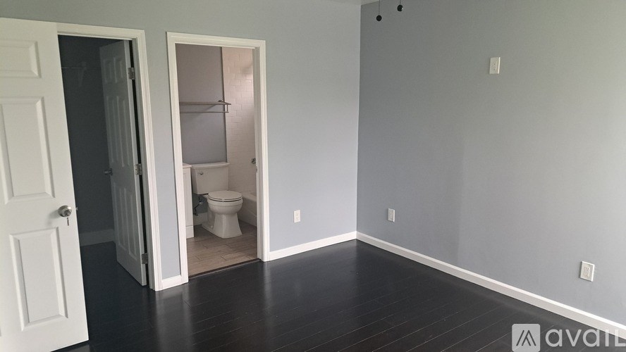 A room with a toilet and a shower in the bathroom.