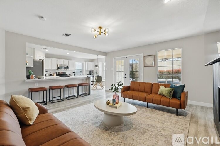 A living room with a brown leather couch and a white coffee table.