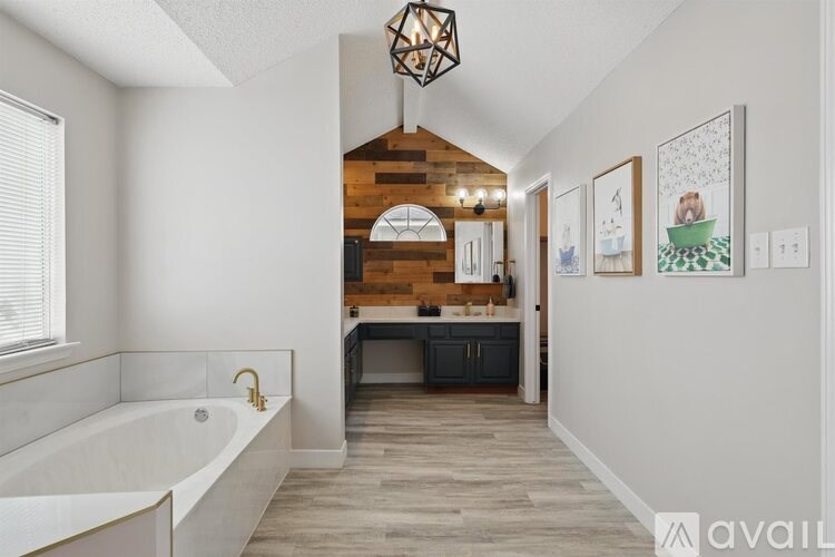 A bathroom with a large tub and wooden accents.