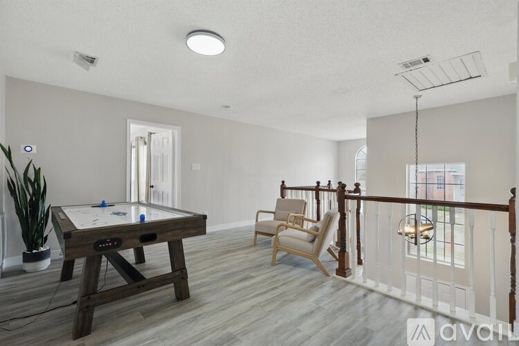 A room with a pool table and a chair.