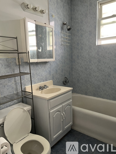 A bathroom with a toilet, sink, and bathtub.