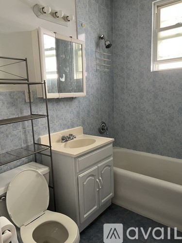 A bathroom with a toilet, sink, and bathtub.