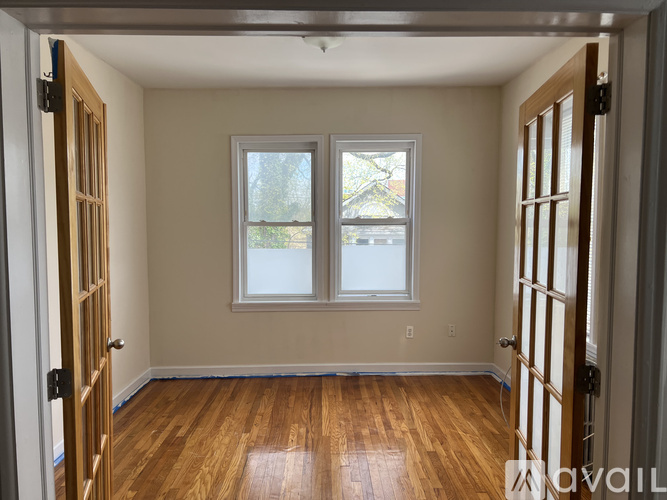 A room with wooden floors and a window.