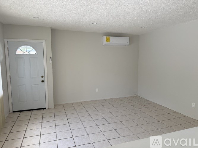 A room with a door and a tiled floor.