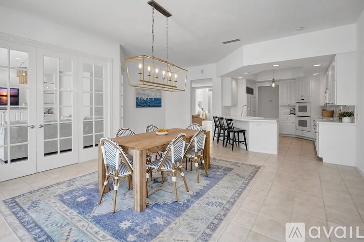 A dining room with a wooden table and chairs.