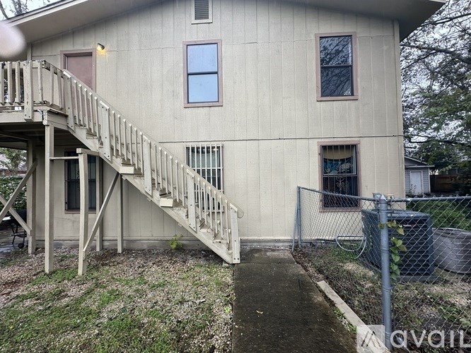 A house with a staircase leading to the front door.