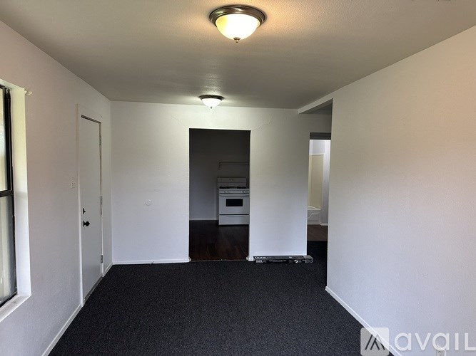 A room with a black carpet and white walls.