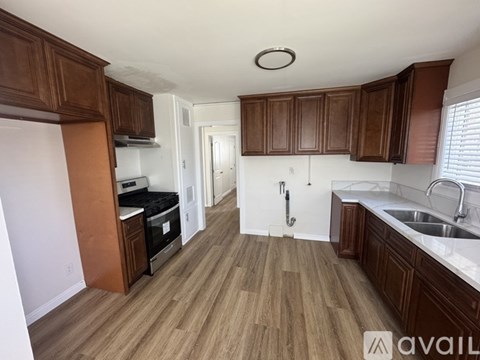 A kitchen with wooden cabinets and a white countertop.