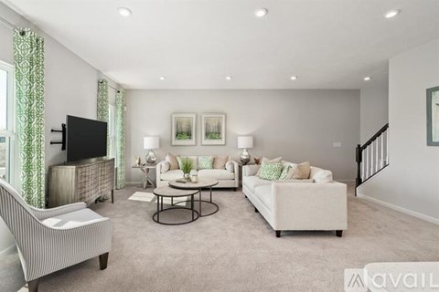 A living room with a television, sofa, and coffee table.