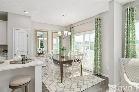 A dining room with a table set for six.