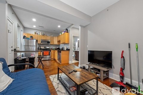 A living room with a blue couch and a television.