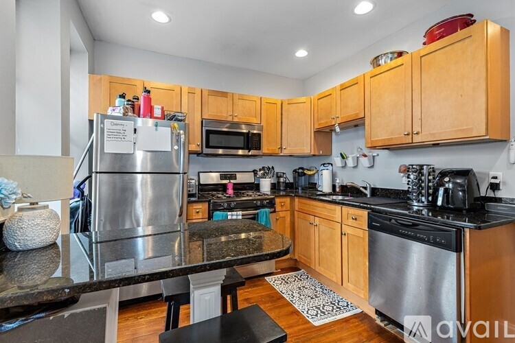 A kitchen with wooden cabinets and a granite countertop.