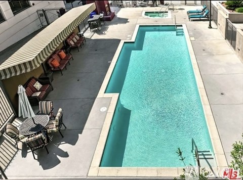 A pool with a table and chairs around it.