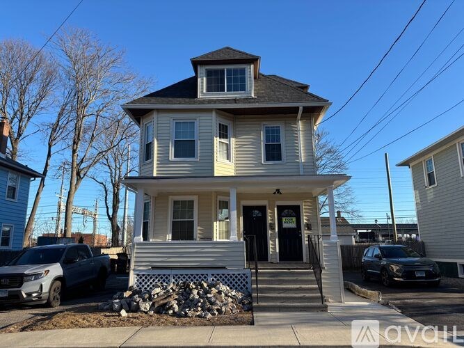 A two-story house with a front porch and a garage.