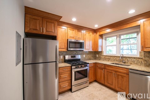 A kitchen with wooden cabinets and stainless steel appliances.