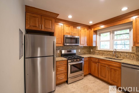 A kitchen with wooden cabinets and stainless steel appliances.