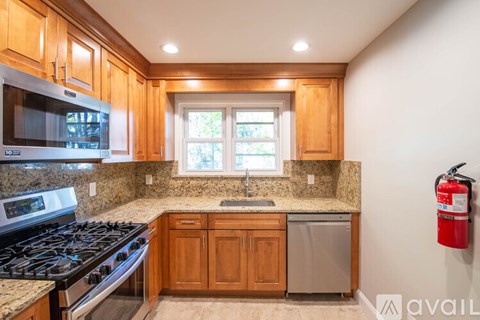 A kitchen with wooden cabinets and a granite countertop.