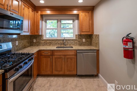 A kitchen with wooden cabinets and a granite countertop.