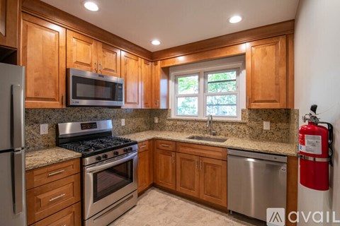 A kitchen with wooden cabinets and stainless steel appliances.
