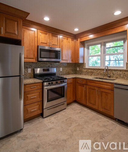 A kitchen with wooden cabinets and stainless steel appliances.