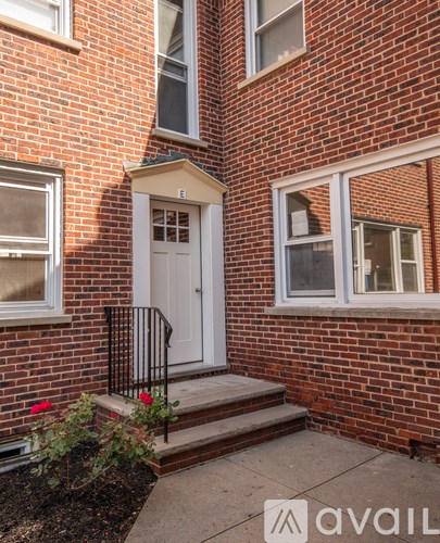 A brick house with a white door and windows.