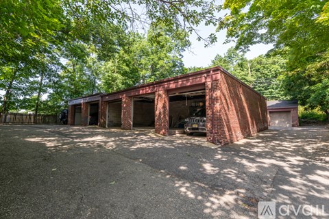 A red brick building with a car parked in front.