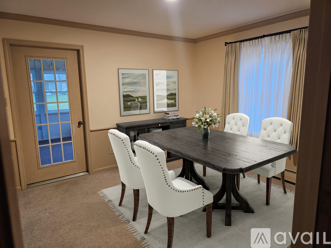 A dining room with a table set for four.