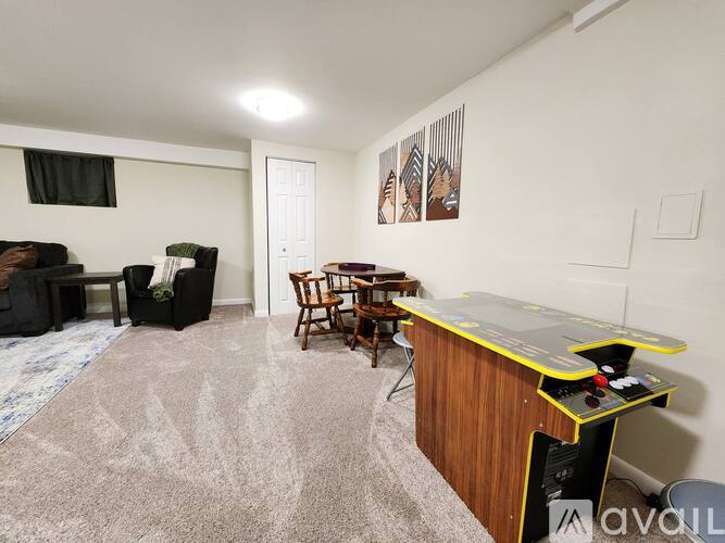 A room with a pool table and a couch.