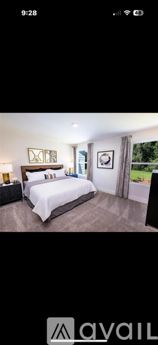 A well-lit bedroom with a large bed and a window.