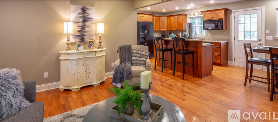 A modern kitchen with wooden floors and a large island.