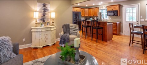 A modern kitchen with wooden floors and a large island.