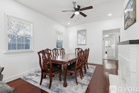 A dining room with a table and chairs.