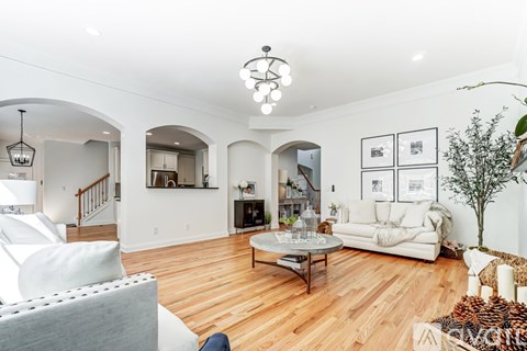 A living room with a white couch and a coffee table.