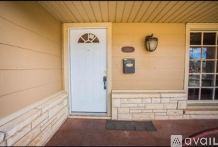 A white door is on the left and a window is on the right.