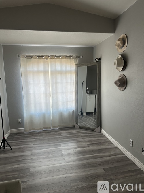 A bedroom with a bed, nightstand, and dresser.