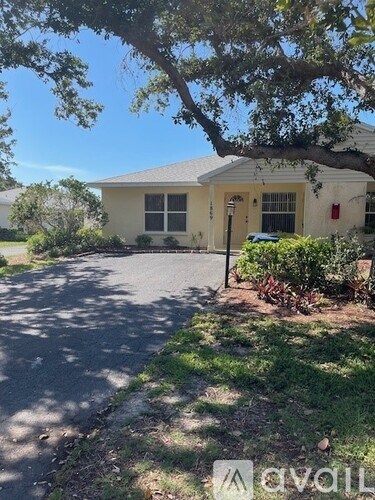 A house with a tree in front of it.