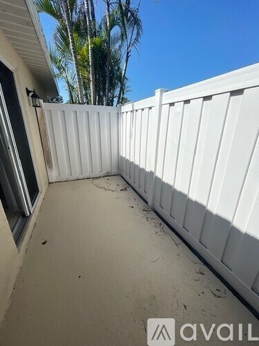 A white fence is in the foreground of the image.