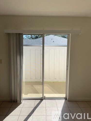 A room with a sliding glass door leading to a balcony.