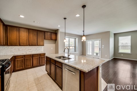 A kitchen with brown cabinets and a granite countertop.