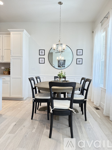 A dining room with a table set for four.